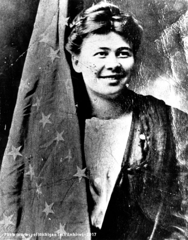 “Big Annie” Clemenc, pictured with the American flag she marched in the strikes with - Michigan Tech Archives