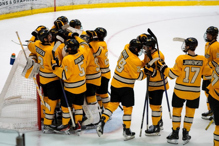 Huskies+celebrate+their+5-4+victory+over+St.+Thomas+on+Saturday%2C+March+4th%2C+Photo+taken+by+Joe+Schallmo.%0A
