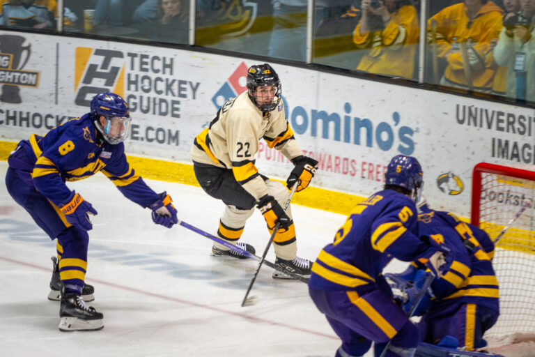 Marcus Pedersen (22) approaches heavily guarded net